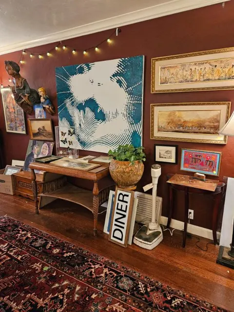 Gallery wall of framed art and antiques