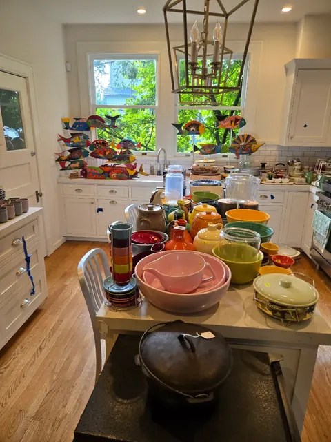Kitchen staged with colorful pottery and cookware