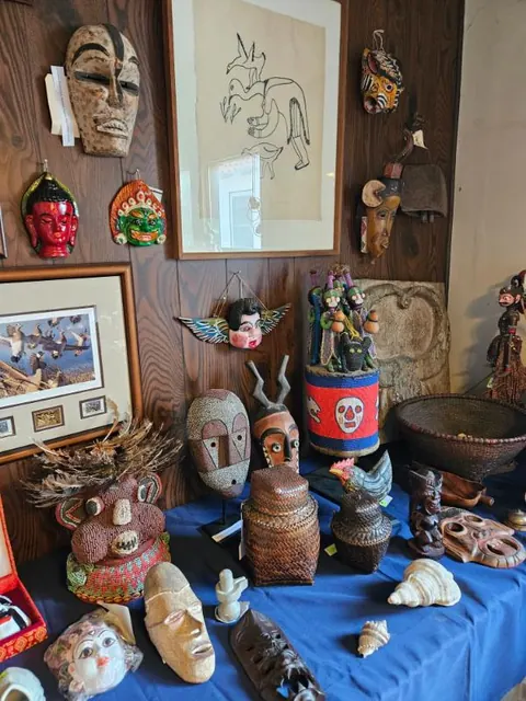 Collection of masks and folk art, staged for sale