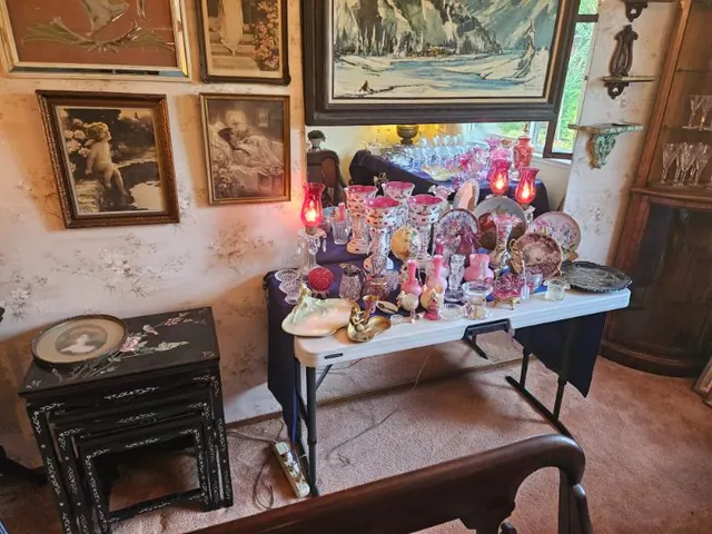 Cranberry and pink glassware staged with artwork
