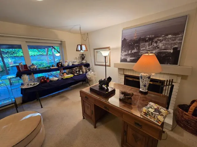 Silver and serving pieces staged in a living room