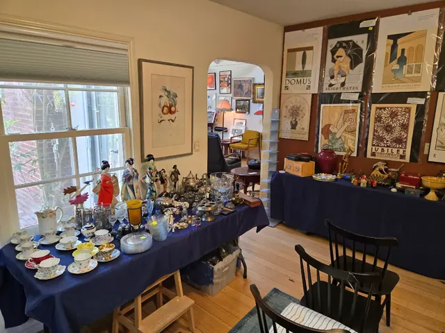 Teacup collection and vintage posters staged for sale