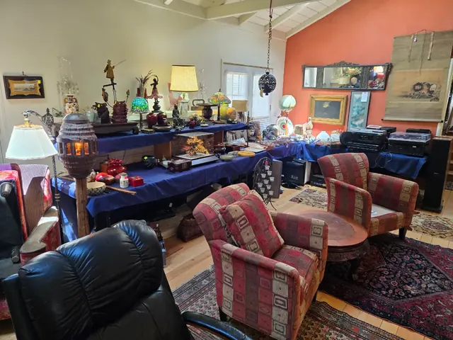 Lamps, stained glass and collectibles staged on tables
